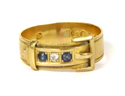 Lot 92 - An 18ct gold diamond and sapphire buckle ring