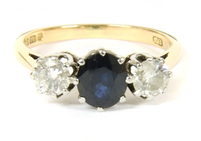 Lot 307 - An 18ct gold three stone sapphire and diamond ring