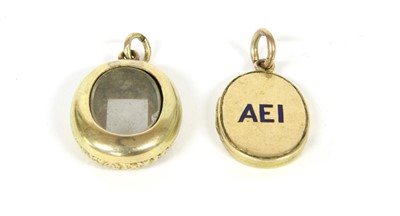 Lot 15 - A gold enamel oval locket