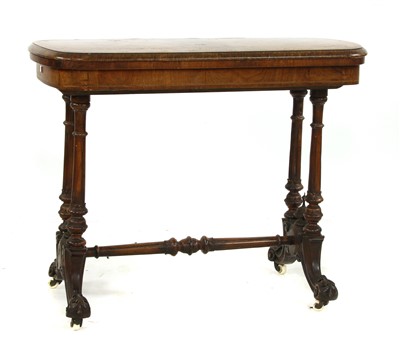 Lot 668 - A Victorian inlaid walnut fold over card table