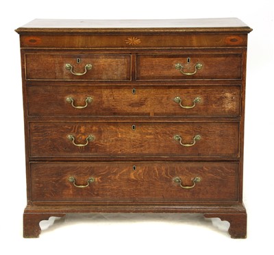 Lot 674 - A George III oak chest of two short over three long graduated drawers