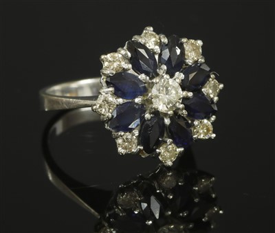 Lot 259 - A white gold diamond and sapphire cluster ring, c.1970