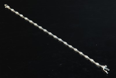 Lot 440 - A 9ct white gold diamond set line bracelet