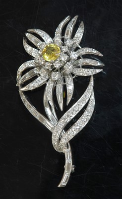 Lot 553 - A platinum yellow sapphire and diamond flowerhead brooch, c.1950