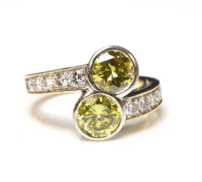 Lot 75 - An 18ct gold two stone diamond crossover ring