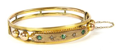 Lot 307 - An Edwardian cased 9ct gold diamond and garnet-and-glass doublet bangle