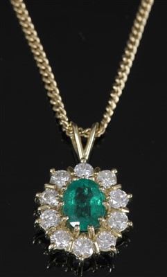Lot 336 - An 18ct gold emerald and diamond cluster pendant