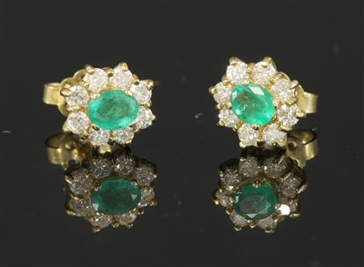 Lot 343 - A pair of gold emerald and diamond cluster earrings