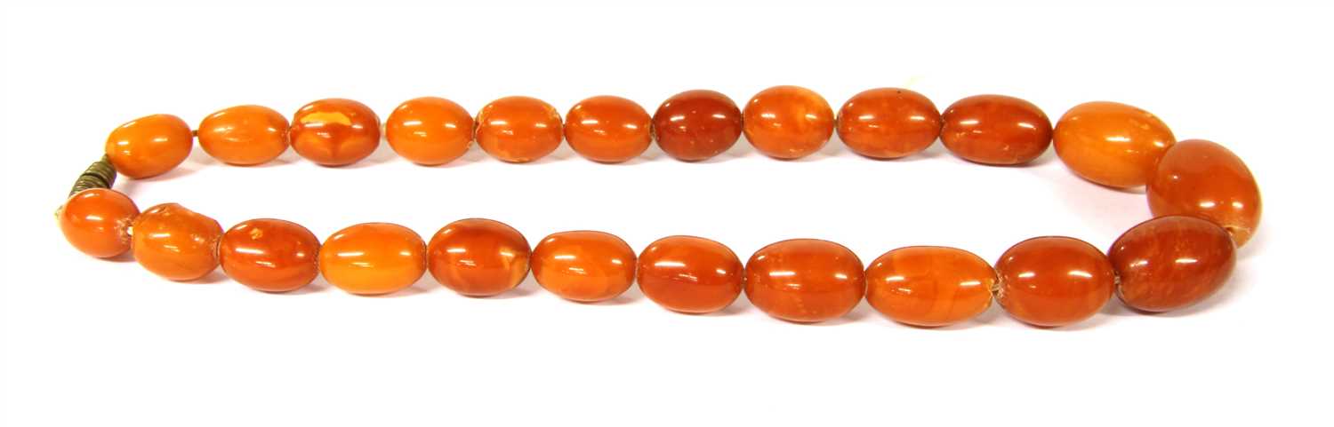Lot 13 - A single row graduated oval butterscotch amber bead necklace