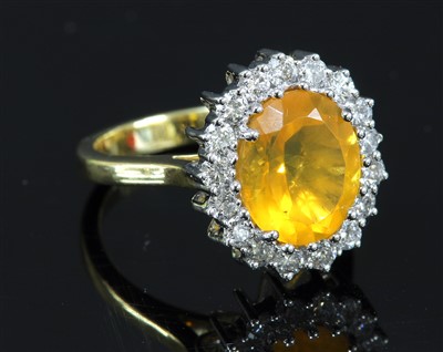 Lot 507 - An 18ct gold fire opal and diamond cluster ring