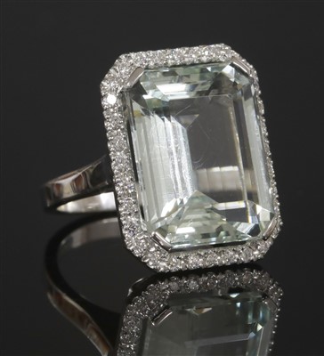 Lot 450 - An Italian white gold aquamarine and diamond halo cluster ring
