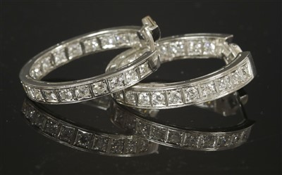 Lot 545 - A pair of Continental white gold diamond hoop earrings