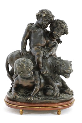 Lot 110 - A bronze group of putti playing with a leopard