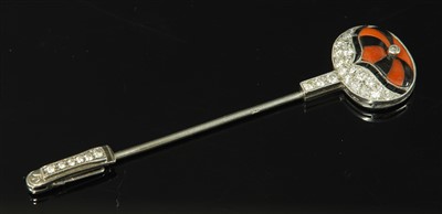 Lot 173 - An Art Deco platinum, coral, black paste and diamond set jockey cap jabot or stick pin, c,.1925