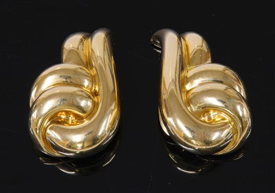 Lot 503 - A pair of gold entwined swirl earrings