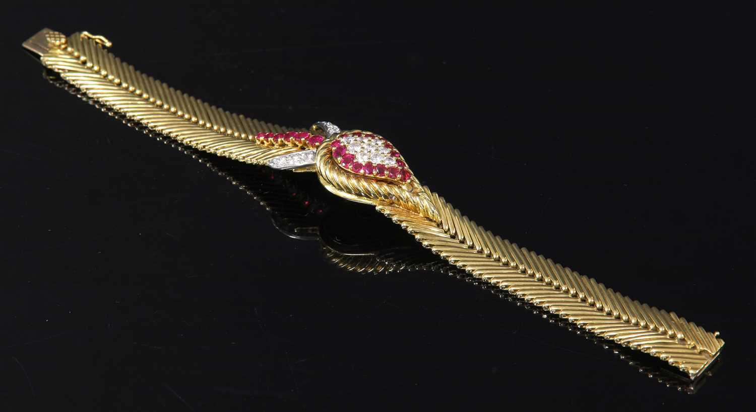 Lot 229 - An 18ct gold ruby and diamond set Jaeger-LeCoultre mechanical back wind cocktail watch, c.1950