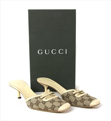 Lot 1045 - A pair of Gucci monogrammed canvas and cream leather mules