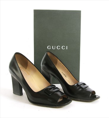 Lot 1041 - A pair of Gucci black leather peep toe court shoes