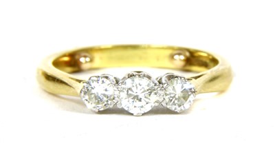 Lot 299 - An 18ct gold three stone diamond ring