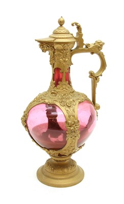 Lot 566 - A Victorian gilt metal and cranberry glass ewer