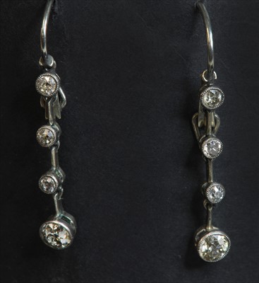 Lot 121 - A pair of gold diamond drop earrings