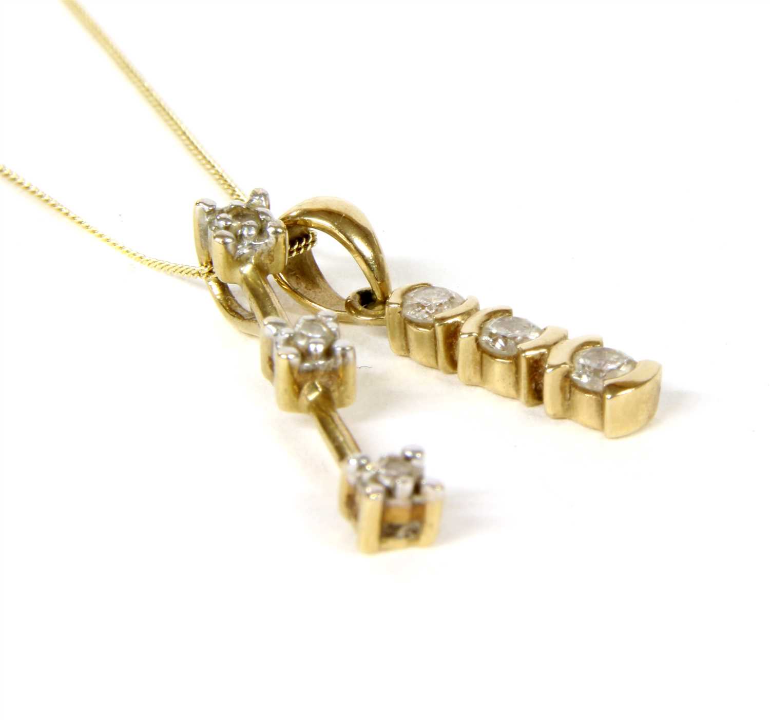 Lot 67 - A gold three stone diamond pendant