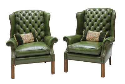 Lot 920 - A pair of green leather wing armchairs