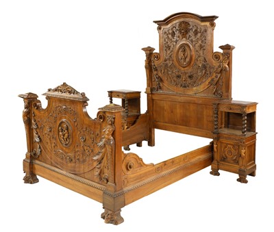 Lot 873 - An elaborately carved French walnut bed