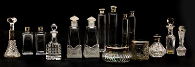 Lot 241 - A collection of various silver topped perfume bottles and dressing jars