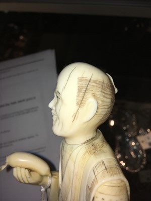 Lot 126 - A Japanese carved ivory figure of a vegetable seller