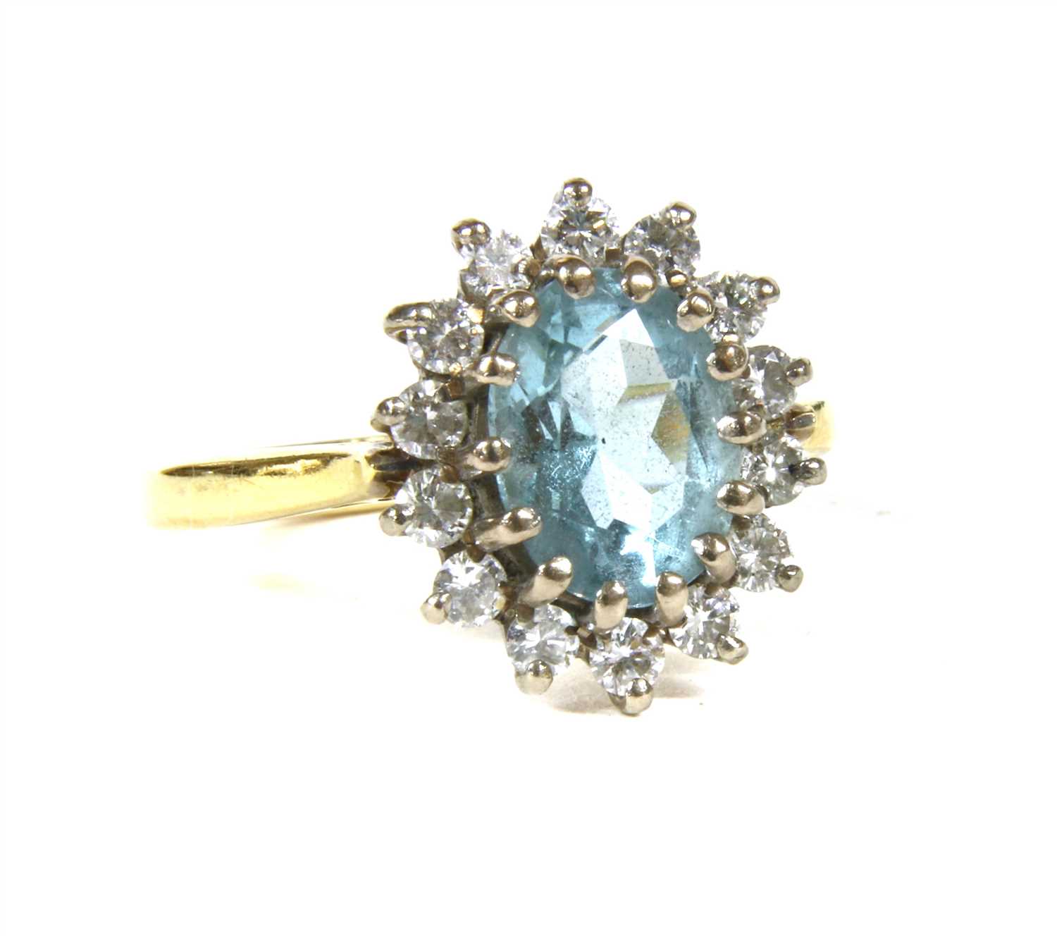 Lot 3 - An 18ct gold aquamarine and diamond oval cluster ring