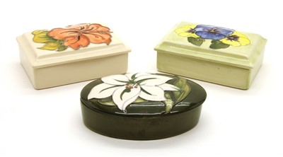 Lot 337 - A collection of three various Moorcroft lidded trinket boxes