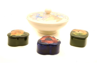 Lot 209 - A Moorcroft lidded dish together with three smaller lidded trinket boxes (4)
