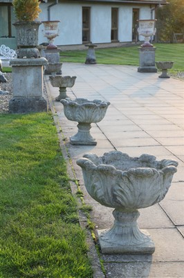 Lot 934 - A set of eight reconstituted stone garden urns