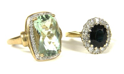 Lot 1045 - A gold sapphire and diamond oval cluster ring