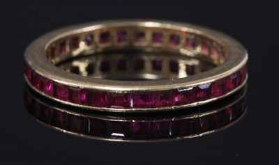 Lot 146 - A gold ruby flat section full eternity ring