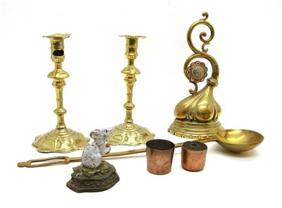 Lot 237 - A pair of 18th century brass petal base candlesticks