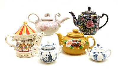 Lot 307 - A collection of 27 decorative teapots