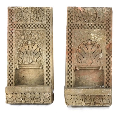 Lot 743 - A pair of sandstone wall sconces
