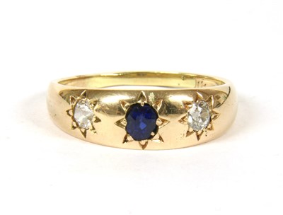 Lot 1059 - A gold sapphire and diamond three stone ring