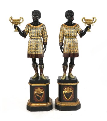 Lot 681 - A pair of Venetian carved ebonised and polychrome painted blackamoors