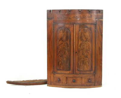Lot 614 - A George III mahogany hanging corner cabinet