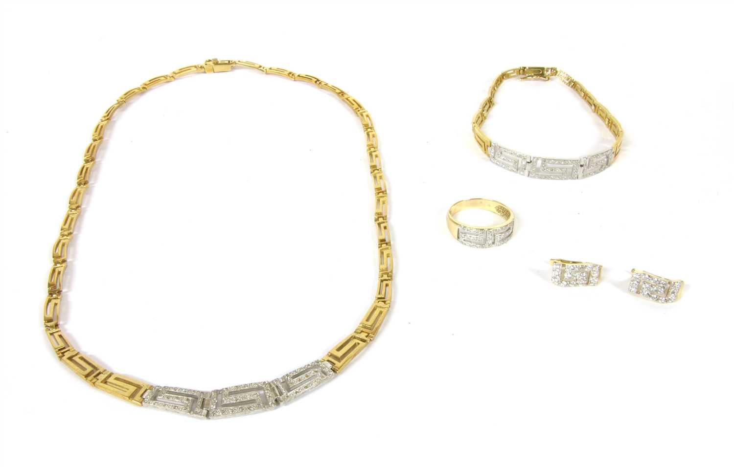 Lot 1064 - A gold, silver and curbic zirconia Greek key design ring, earring, necklace and bracelet suite