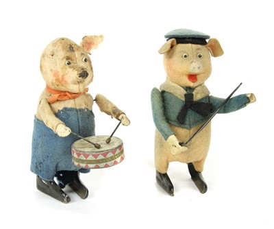Lot 1174 - Two Schuco clockwork felt toy pig musicians
