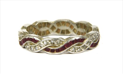 Lot 32 - A platinum ruby and diamond full eternity ring