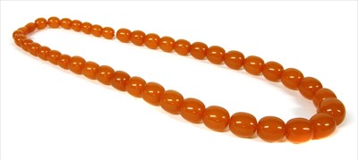 Lot 71 - A single row graduated barrel shaped amber bead necklace