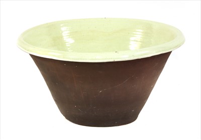 Lot 203 - A large green slip glazed terracotta bowl