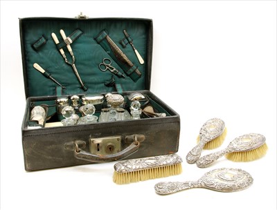 Lot 78 - A leather dressing case containing silver plated fittings