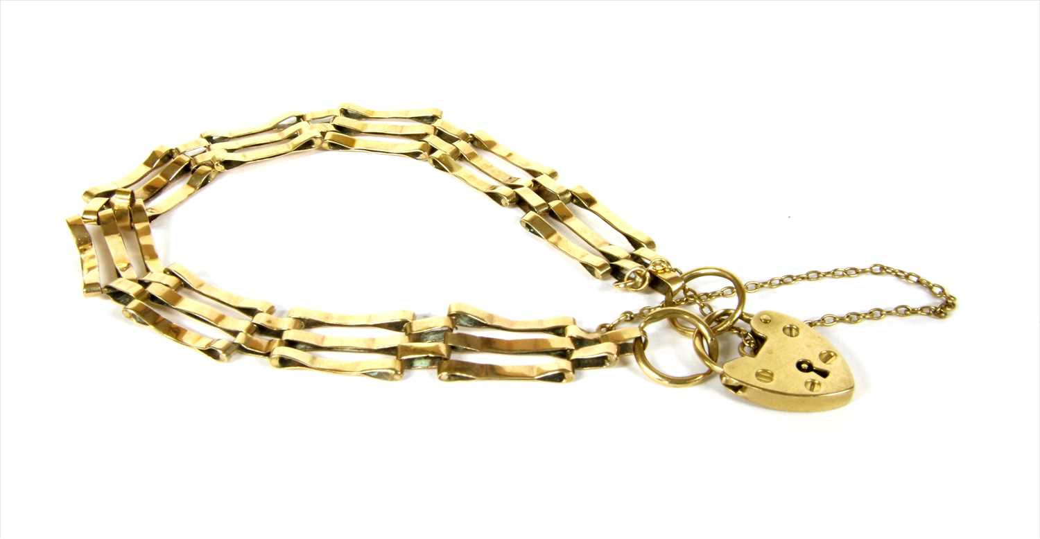 Lot 10 - A 9ct gold three row gate bracelet