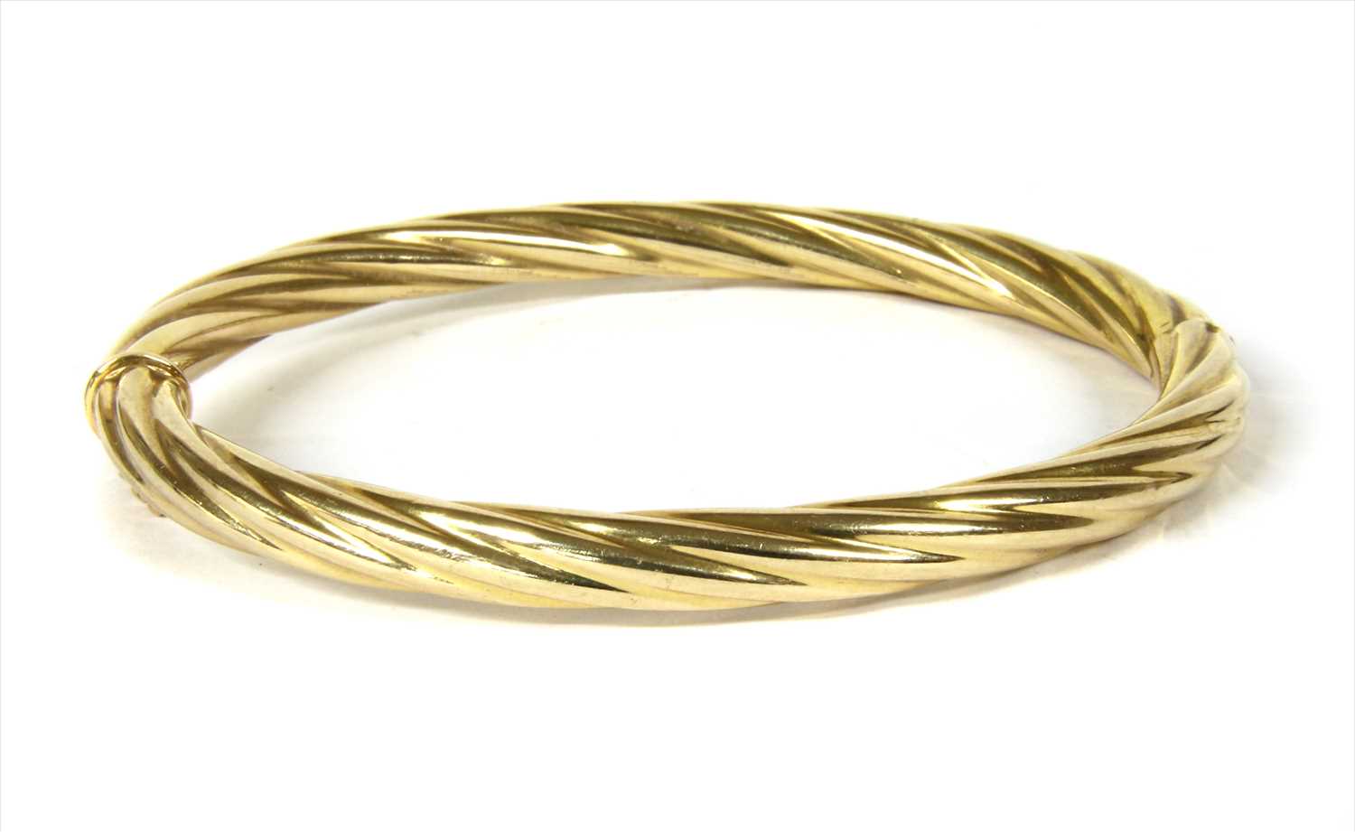 Lot 12 - An Italian 9ct gold hinged twisted wire bangle